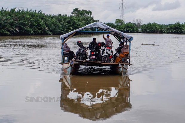 Warga menggunakan jasa perahu penyeberangan di Dermaga Kera-kera sebagai alat transportasi ke Pulau Lakkang, Makassar, Rabu (16/01/2023). Foto: Maman Sukirman