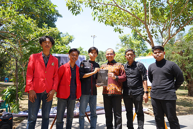 Pengurus UKM Fotogarfi Unhas bersama Prof. drg. Muhammad Ruslin memberikan buku fotografi di kegiatan pameran pojok UKM Fotgrafi Unhas  yang bertema “Sequence”  di Taman Pintu 1 Unhas.