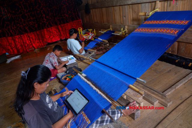 Nita Basongan, perempuan penenun sedang mengkases Pegadaian Digital di Dusun Lembang, Desa Sadan Andulan, Kecamatan Sadang, Toraja Utara, Rabu (4/9/2024).