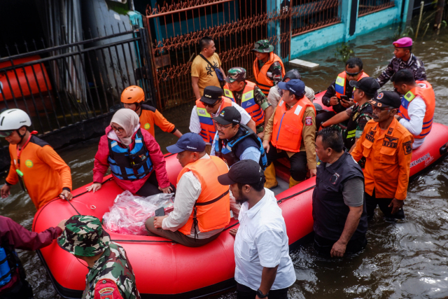 Menteri Sosial (Mensos) Saifullah Yusuf menggunakan perahu karet bersama rombongan mengunjungi bencana banjir di Blok 8 Perumnas Antang, Makassar.