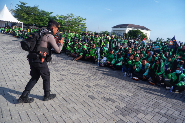 Komunitas pengemudi ojek online (ojol) se-Sulawesi Selatan bersama aparat kepolisian Polda Sulsel tampak berbaur akrab di pelataran Masjid 99 Kubah Asmaul Husnah.